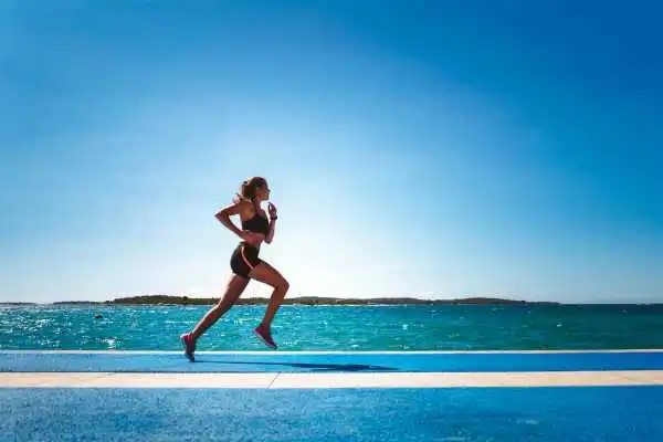 Woman running showing strong leg muscle Wellingborough
